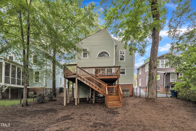 back of house featuring stairs, a deck, a fenced backyard, and central AC
