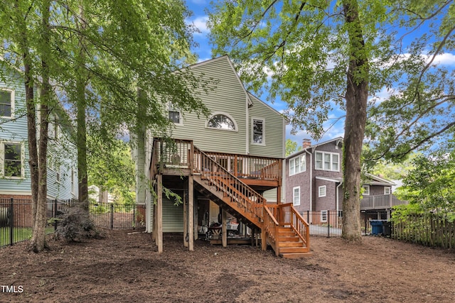 rear view of house with stairs, a fenced backyard, and a wooden deck