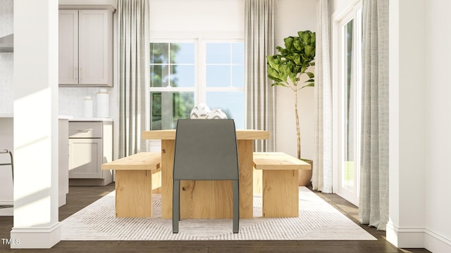 dining space with dark wood-style flooring