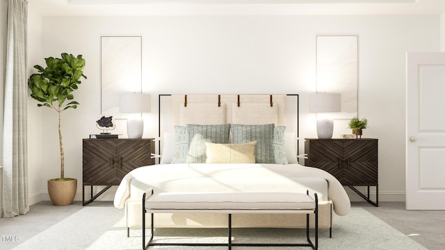 bedroom with light colored carpet and baseboards