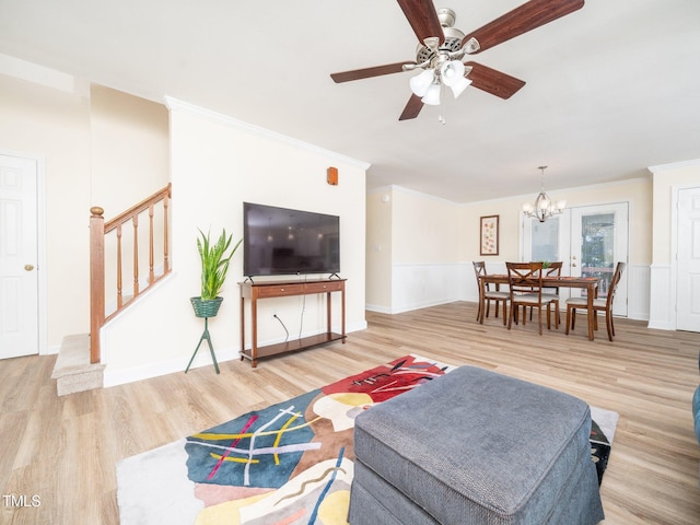 living room featuring stairs, wood finished floors, crown molding, a chandelier, and a ceiling fan