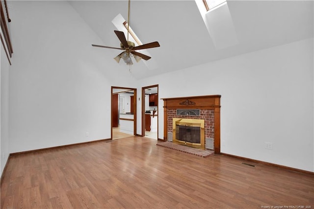 5704 Kindley Dr, Fayetteville, NC 28311 - unfurnished living room with high vaulted ceiling, ceiling fan, wood finished floors, a brick fireplace, and baseboards