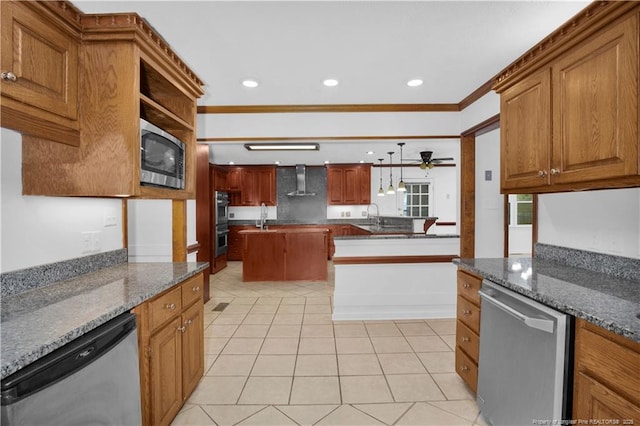 5704 Kindley Dr, Fayetteville, NC 28311 - kitchen with stainless steel appliances, wall chimney range hood, ceiling fan, light tile patterned floors, and recessed lighting