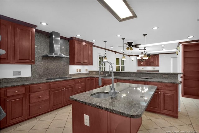 5704 Kindley Dr, Fayetteville, NC 28311 - kitchen with wall chimney range hood, light tile patterned flooring, a center island with sink, dark stone counters, and a sink