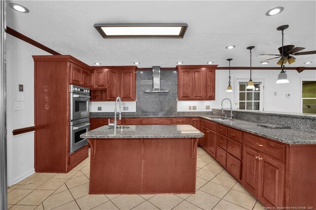 5704 Kindley Dr, Fayetteville, NC 28311 - kitchen featuring wall chimney exhaust hood, double oven, a sink, a peninsula, and recessed lighting