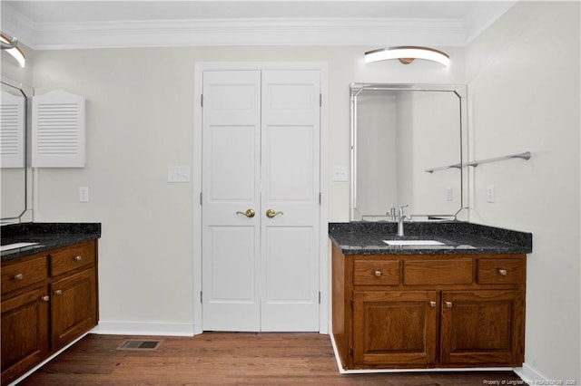 5704 Kindley Dr, Fayetteville, NC 28311 - full bathroom featuring wood finished floors, crown molding, baseboards, two vanities, and a closet