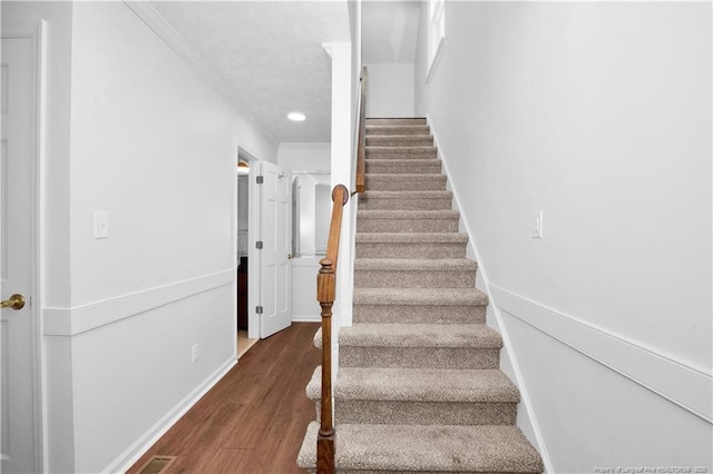 5704 Kindley Dr, Fayetteville, NC 28311 - staircase featuring ornamental molding, wood finished floors, baseboards, recessed lighting, and a textured ceiling