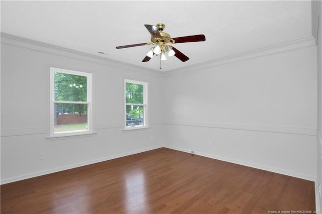 5704 Kindley Dr, Fayetteville, NC 28311 - spare room with crown molding, dark wood-style floors, ceiling fan, and baseboards
