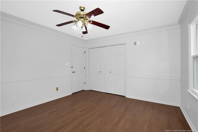 5704 Kindley Dr, Fayetteville, NC 28311 - unfurnished bedroom featuring dark wood-style flooring, crown molding, a closet, ceiling fan, and baseboards
