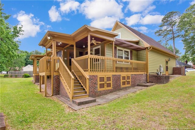 5704 Kindley Dr, Fayetteville, NC 28311 - back of property featuring ceiling fan, a yard, and stairs