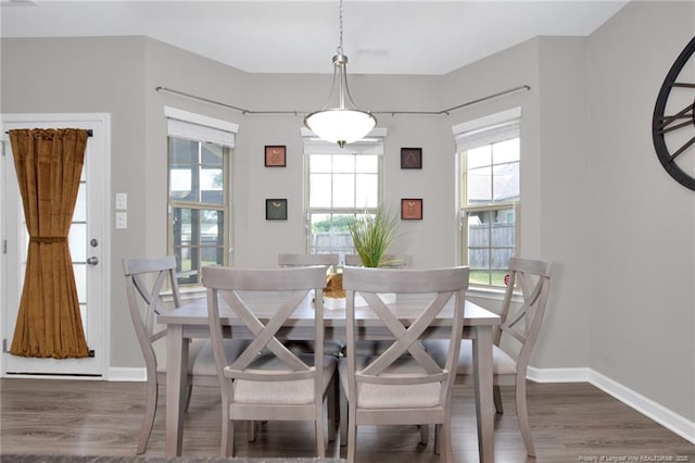 dining area with plenty of natural light, wood finished floors, and baseboards