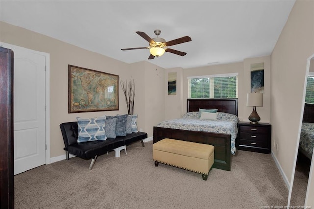 bedroom with light carpet, baseboards, and a ceiling fan
