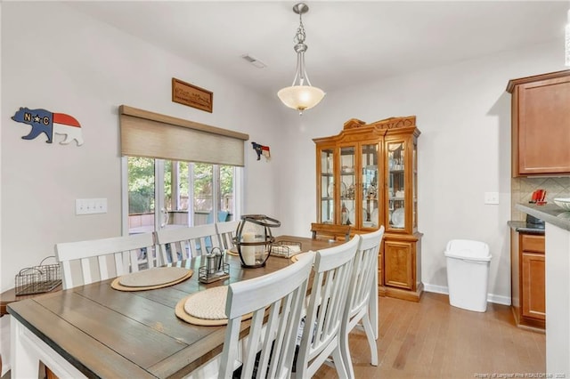 dining area featuring light wood-type flooring