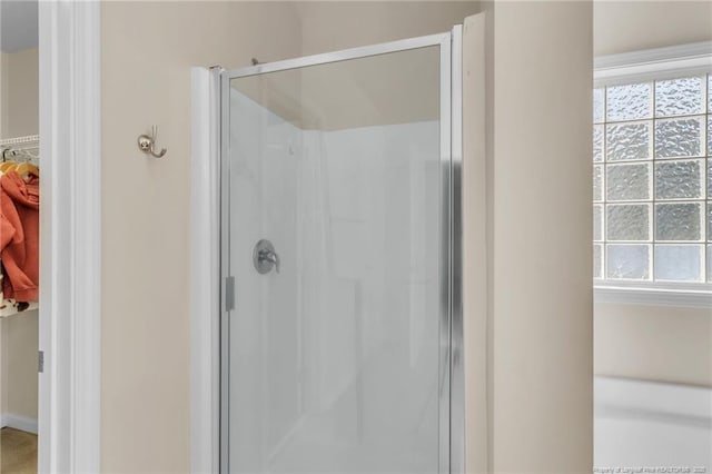 bathroom featuring a stall shower and healthy amount of natural light