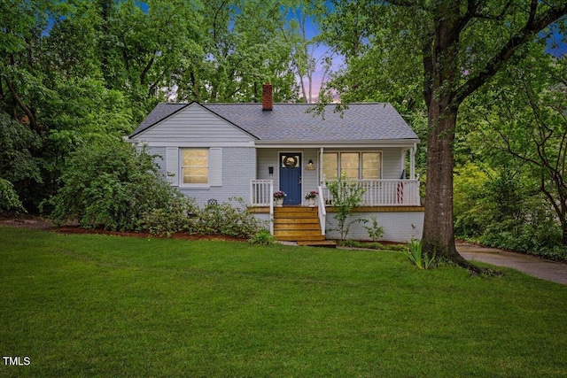 2324 Stevens Rd, Raleigh, NC 27610 - view of front of property with covered porch, a chimney, a yard, and roof with shingles