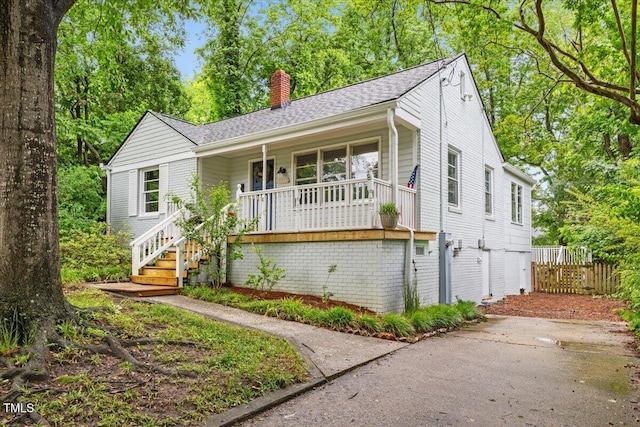 2324 Stevens Rd, Raleigh, NC 27610 - ranch-style home featuring a porch, a chimney, stairway, fence, and roof with shingles