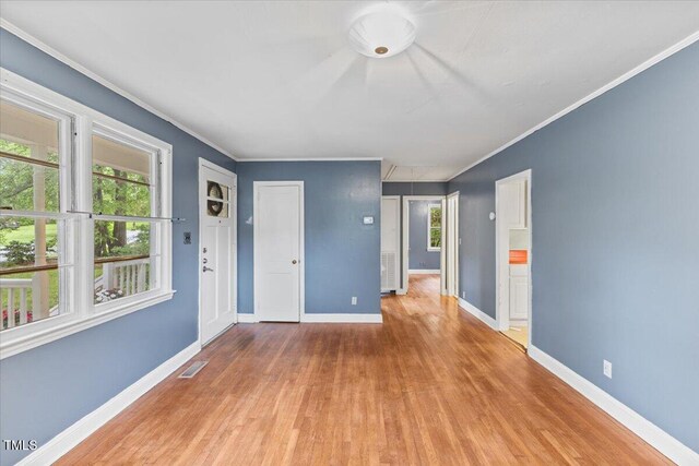 2324 Stevens Rd, Raleigh, NC 27610 - empty room featuring wood finished floors, plenty of natural light, ornamental molding, and baseboards