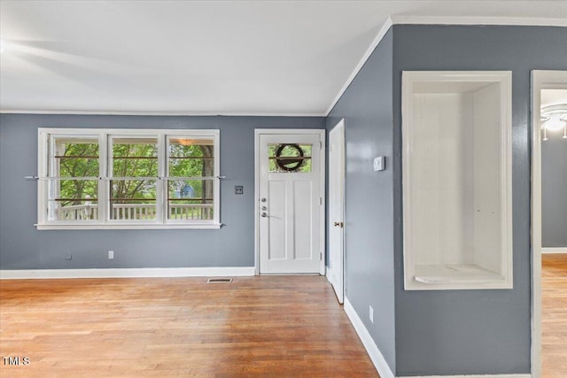 2324 Stevens Rd, Raleigh, NC 27610 - foyer entrance featuring crown molding, wood finished floors, and baseboards