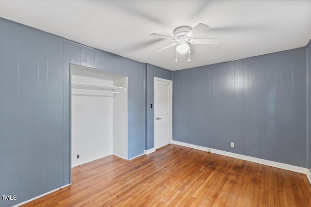 2324 Stevens Rd, Raleigh, NC 27610 - unfurnished bedroom with hardwood / wood-style floors, a closet, a ceiling fan, and wooden walls