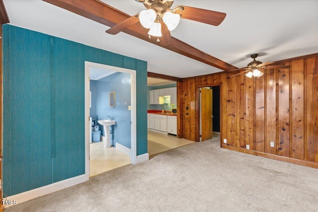 2324 Stevens Rd, Raleigh, NC 27610 - empty room with beamed ceiling, a ceiling fan, carpet flooring, wooden walls, and a sink