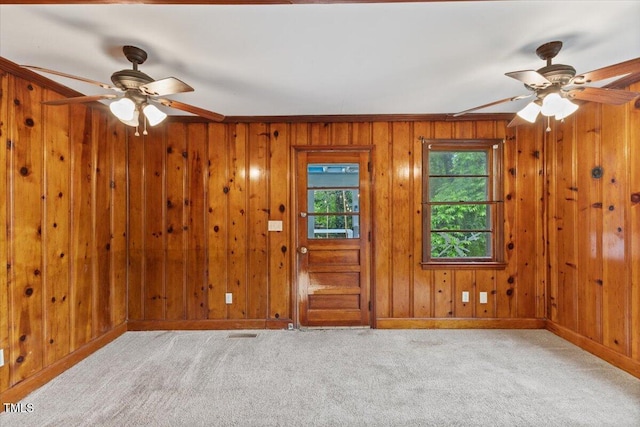 2324 Stevens Rd, Raleigh, NC 27610 - foyer entrance featuring ceiling fan, baseboards, carpet flooring, wooden walls, and ornamental molding