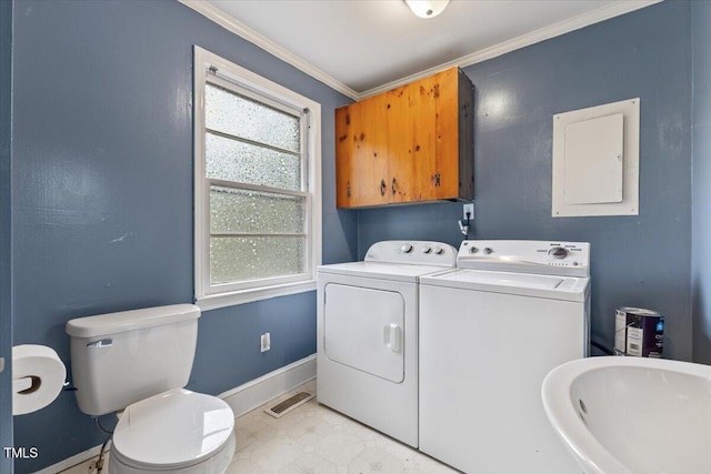 2324 Stevens Rd, Raleigh, NC 27610 - laundry room featuring washing machine and clothes dryer, baseboards, crown molding, and electric panel