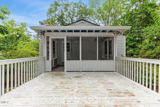 2324 Stevens Rd, Raleigh, NC 27610 - wooden deck featuring a sunroom and a ceiling fan