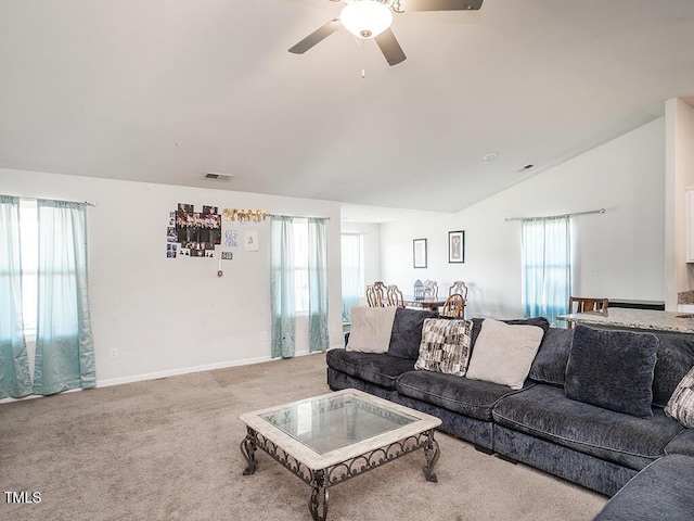living area featuring carpet, a ceiling fan, vaulted ceiling, and baseboards
