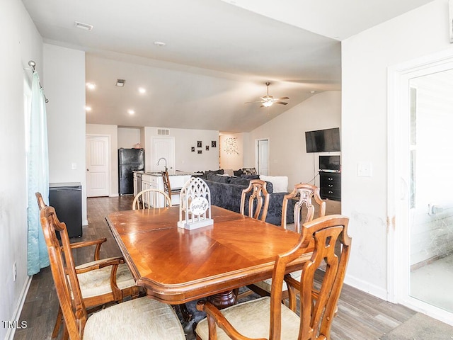 dining area with wood finished floors, ceiling fan, lofted ceiling, and baseboards