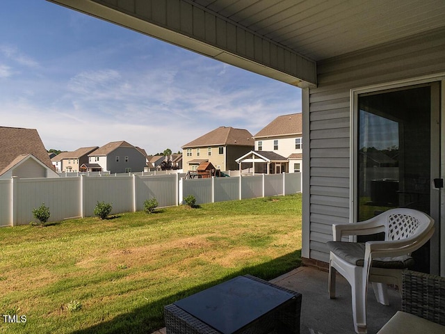 view of yard featuring a residential view and a patio