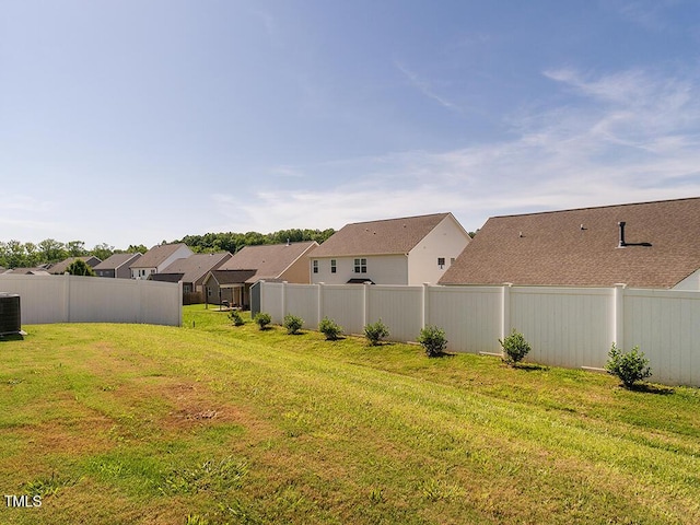view of yard featuring a residential view and central AC