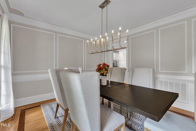 3007 Krogen Ct, Creedmoor, NC 27522 - dining room with light wood-type flooring, a chandelier, and a decorative wall