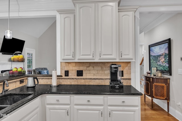 3007 Krogen Ct, Creedmoor, NC 27522 - kitchen featuring a sink, backsplash, dark stone countertops, light wood-style flooring, and white cabinetry