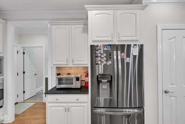3007 Krogen Ct, Creedmoor, NC 27522 - kitchen with stainless steel fridge, dark countertops, light wood-style floors, and white cabinetry