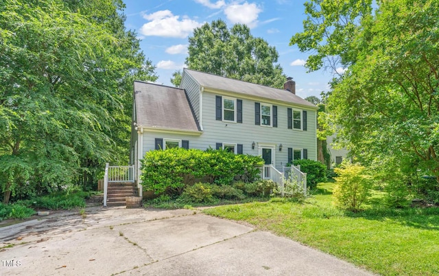 3 Cobble Glen Ct, Durham, NC 27713 - colonial home featuring a chimney and a front yard