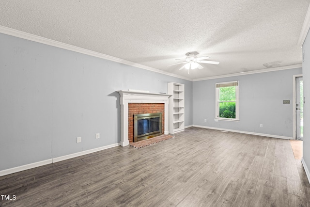 3 Cobble Glen Ct, Durham, NC 27713 - unfurnished living room featuring ceiling fan, a textured ceiling, wood finished floors, a brick fireplace, and crown molding