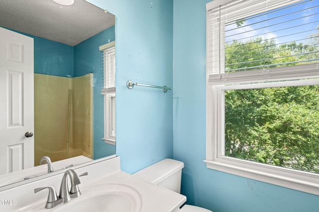 3 Cobble Glen Ct, Durham, NC 27713 - bathroom with healthy amount of natural light, toilet, vanity, and a textured ceiling