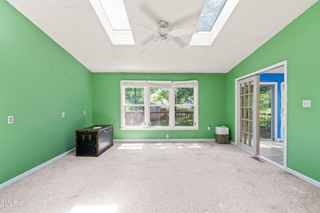 3 Cobble Glen Ct, Durham, NC 27713 - carpeted empty room with a skylight, a textured ceiling, a ceiling fan, baseboards, and vaulted ceiling