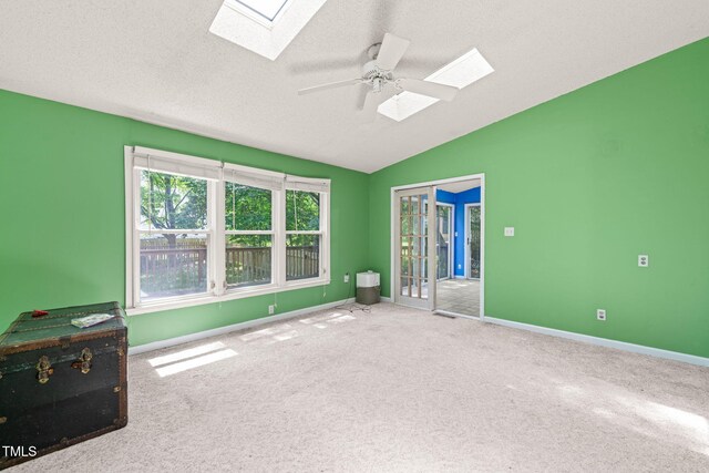 3 Cobble Glen Ct, Durham, NC 27713 - carpeted empty room with a skylight, lofted ceiling, ceiling fan, baseboards, and a textured ceiling