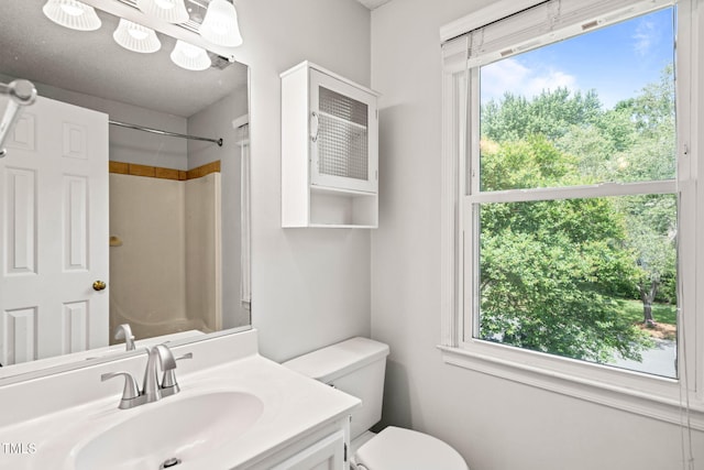3 Cobble Glen Ct, Durham, NC 27713 - bathroom featuring a shower, toilet, vanity, and plenty of natural light