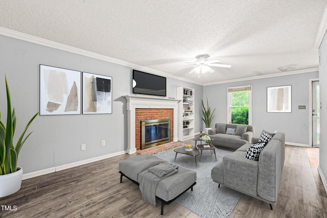3 Cobble Glen Ct, Durham, NC 27713 - living room with a textured ceiling, wood finished floors, ceiling fan, ornamental molding, and a fireplace