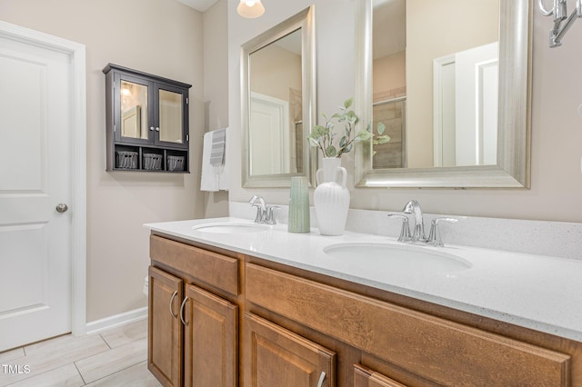 full bathroom featuring double vanity and a shower with door