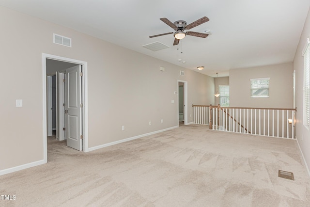 empty room with ceiling fan, carpet floors, and baseboards
