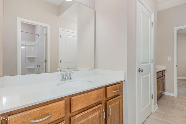 bathroom featuring vanity and baseboards