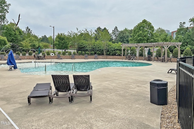 community pool featuring a pergola, fence, and a patio