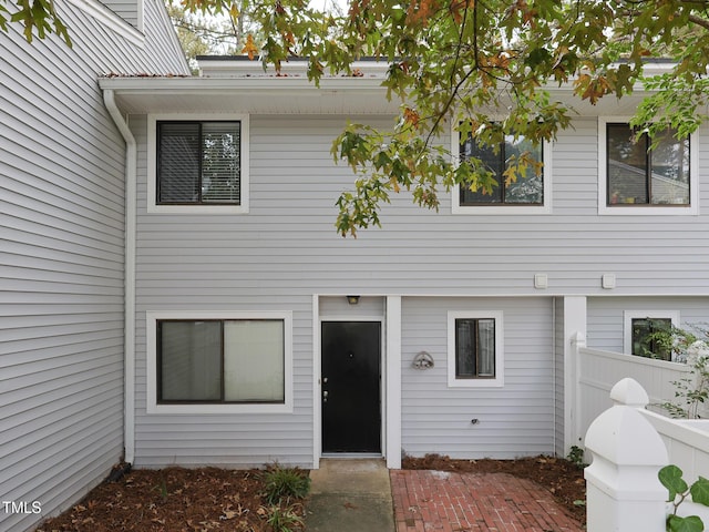doorway to property featuring fence and a patio area