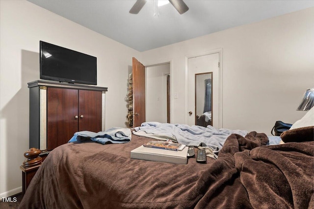 bedroom featuring ceiling fan and baseboards