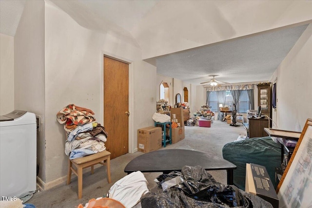 living area featuring carpet, washer / dryer, ceiling fan, and arched walkways