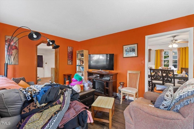 living area featuring wood finished floors and a ceiling fan