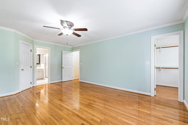 6201 King Croydon Ct, Raleigh, NC 27603 - unfurnished bedroom featuring light wood finished floors, crown molding, a walk in closet, ensuite bath, and a ceiling fan
